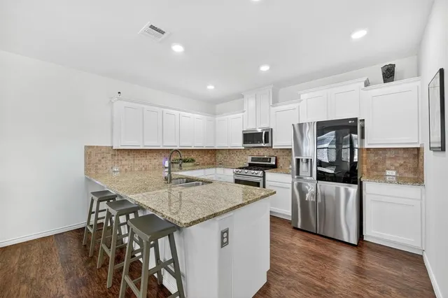 a kitchen with a center island and stainless steel appliances