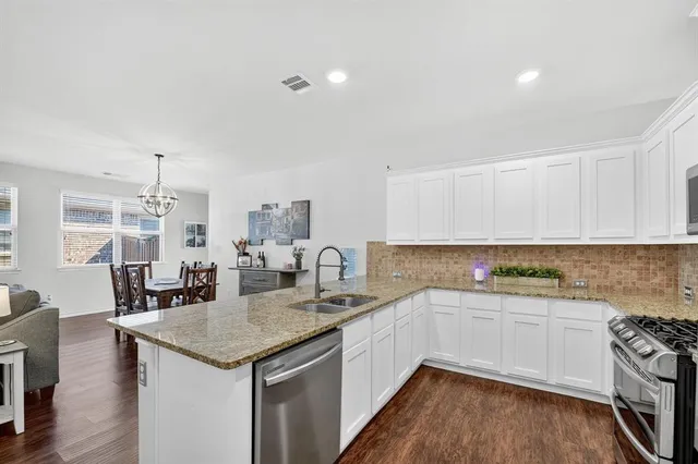 a kitchen with a sink stove and cabinets