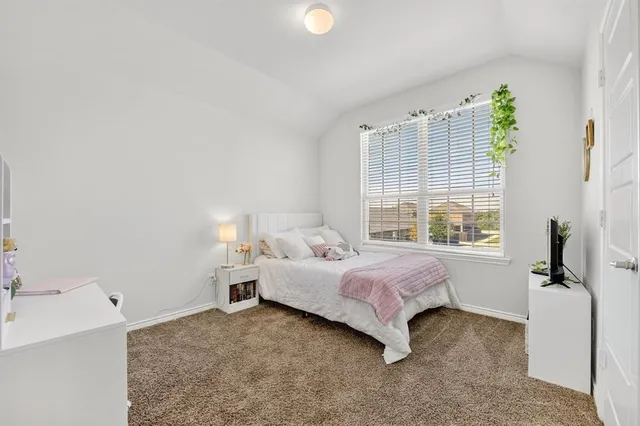 a bed room with a bed and a window