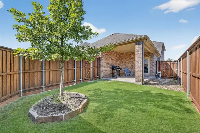 a view of a backyard with table and chairs and a slide