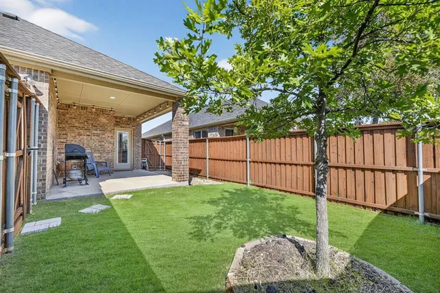 a view of a backyard with a garden and deck