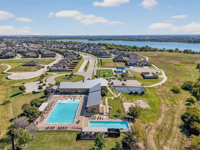 an aerial view of a house with swimming pool and ocean view