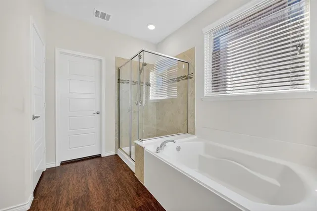 a bathroom with a bathtub and a shower