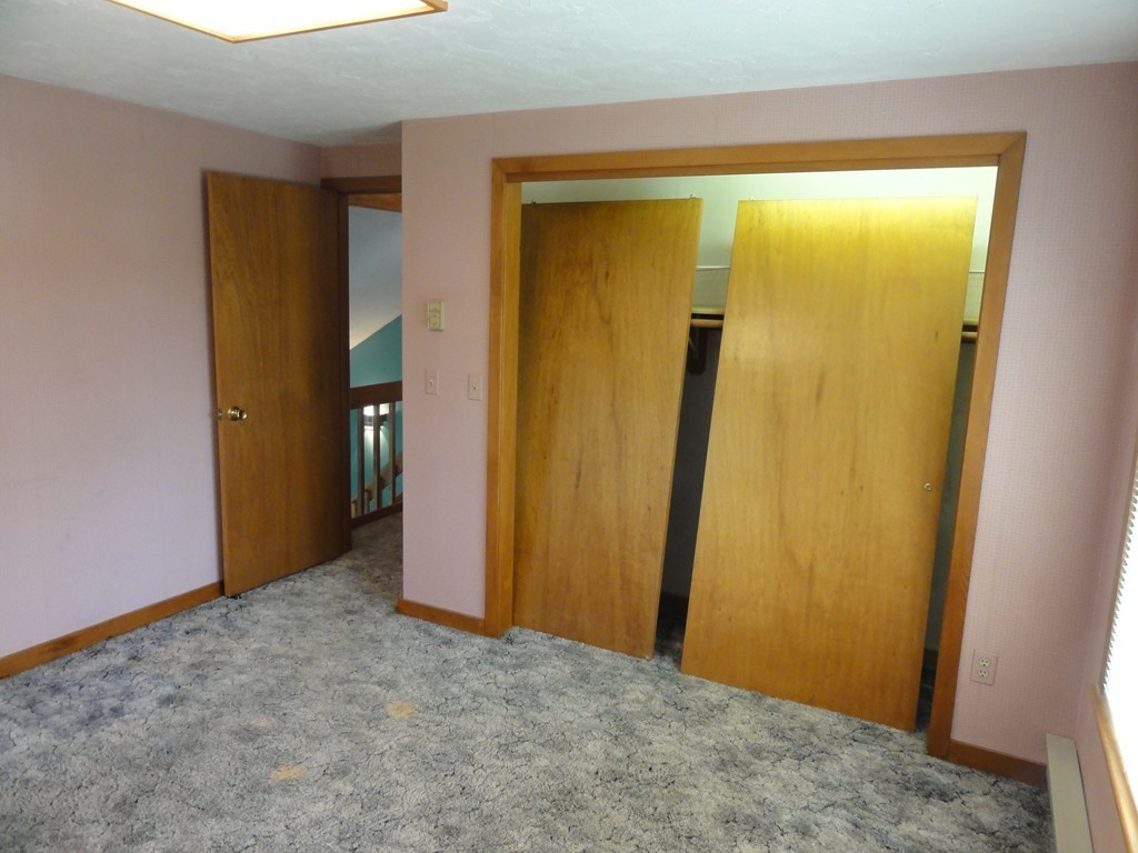 132 Groton Road Shirley, MA 01464 - Photo 21 of 29 a view of a room with a wooden door