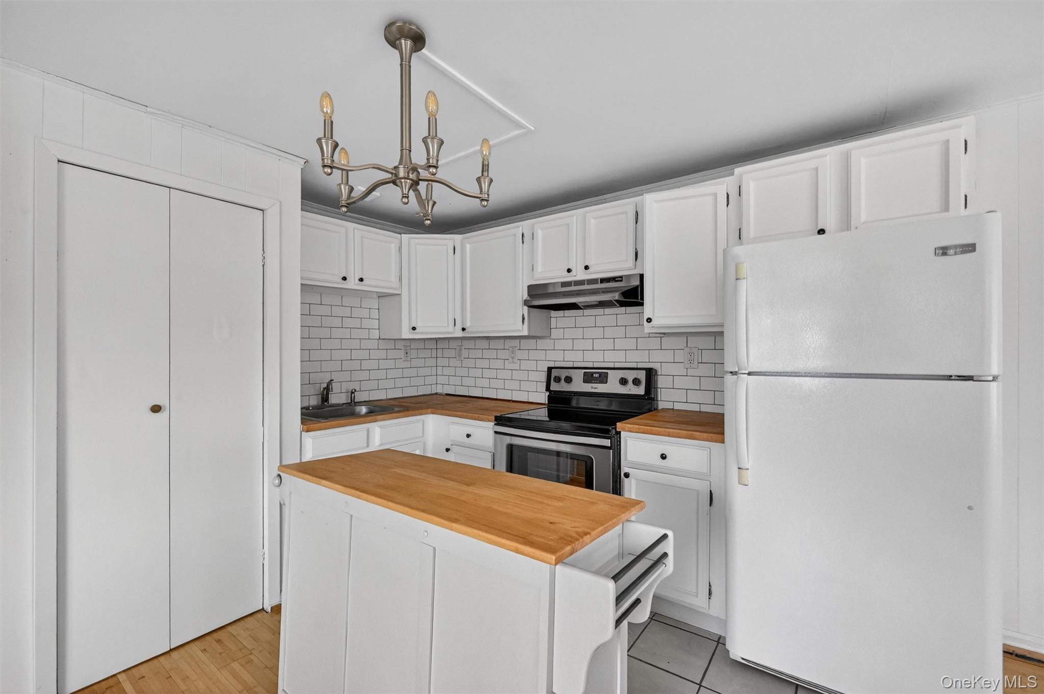 12 Perry Creek Road Washingtonville, NY 10992 - Photo 46 of 48 a kitchen with stainless steel appliances granite countertop a refrigerator a stove a sink dishwasher and a refrigerator with wooden floor