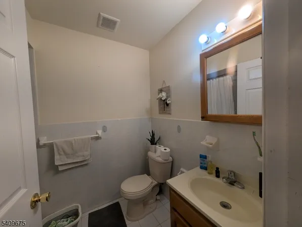 a bathroom with a sink mirror and toilet