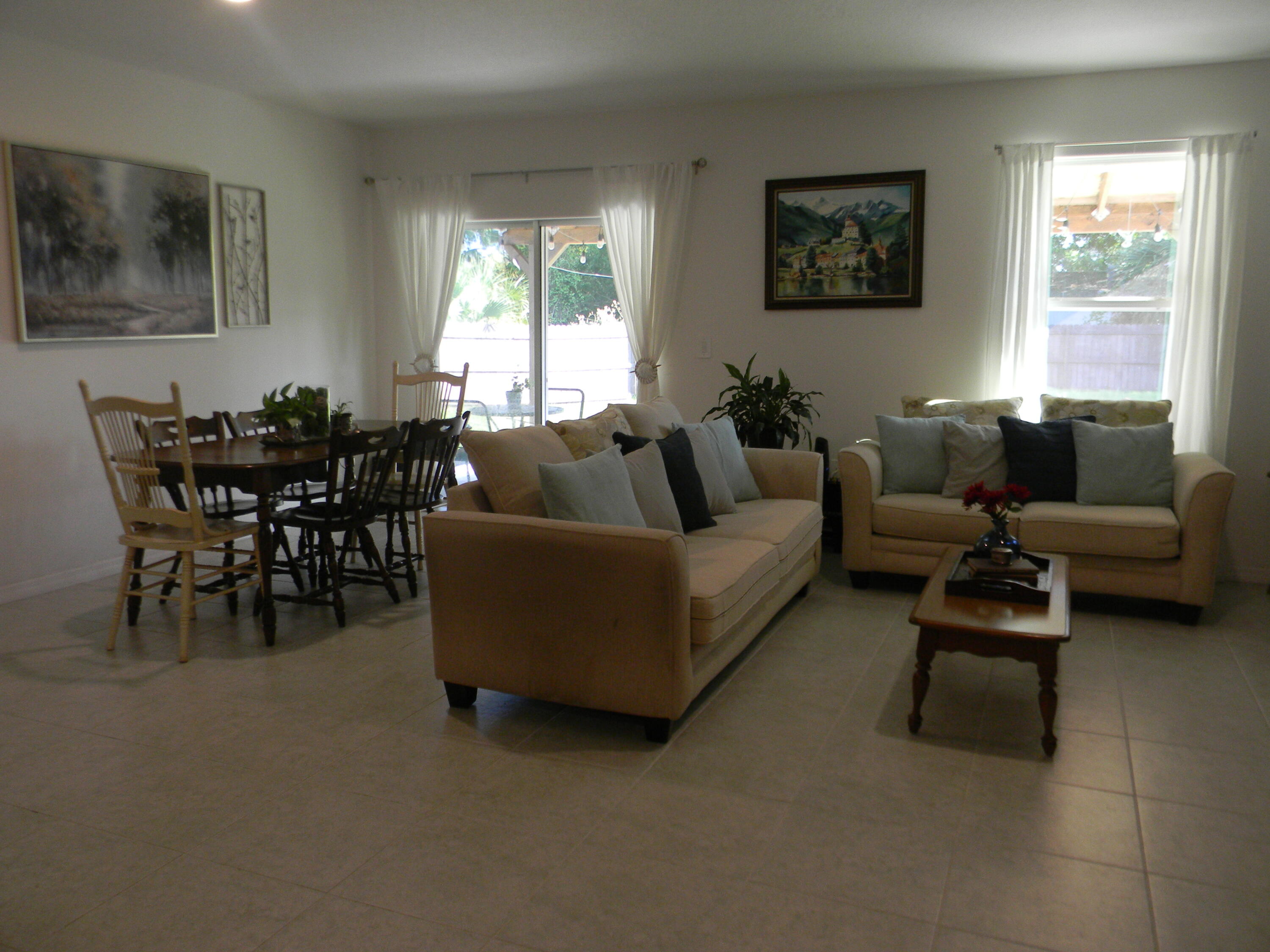 1588 Ranger Road Southeast Palm Bay, FL 32909 - Photo 13 of 52 a living room with furniture and a large window
