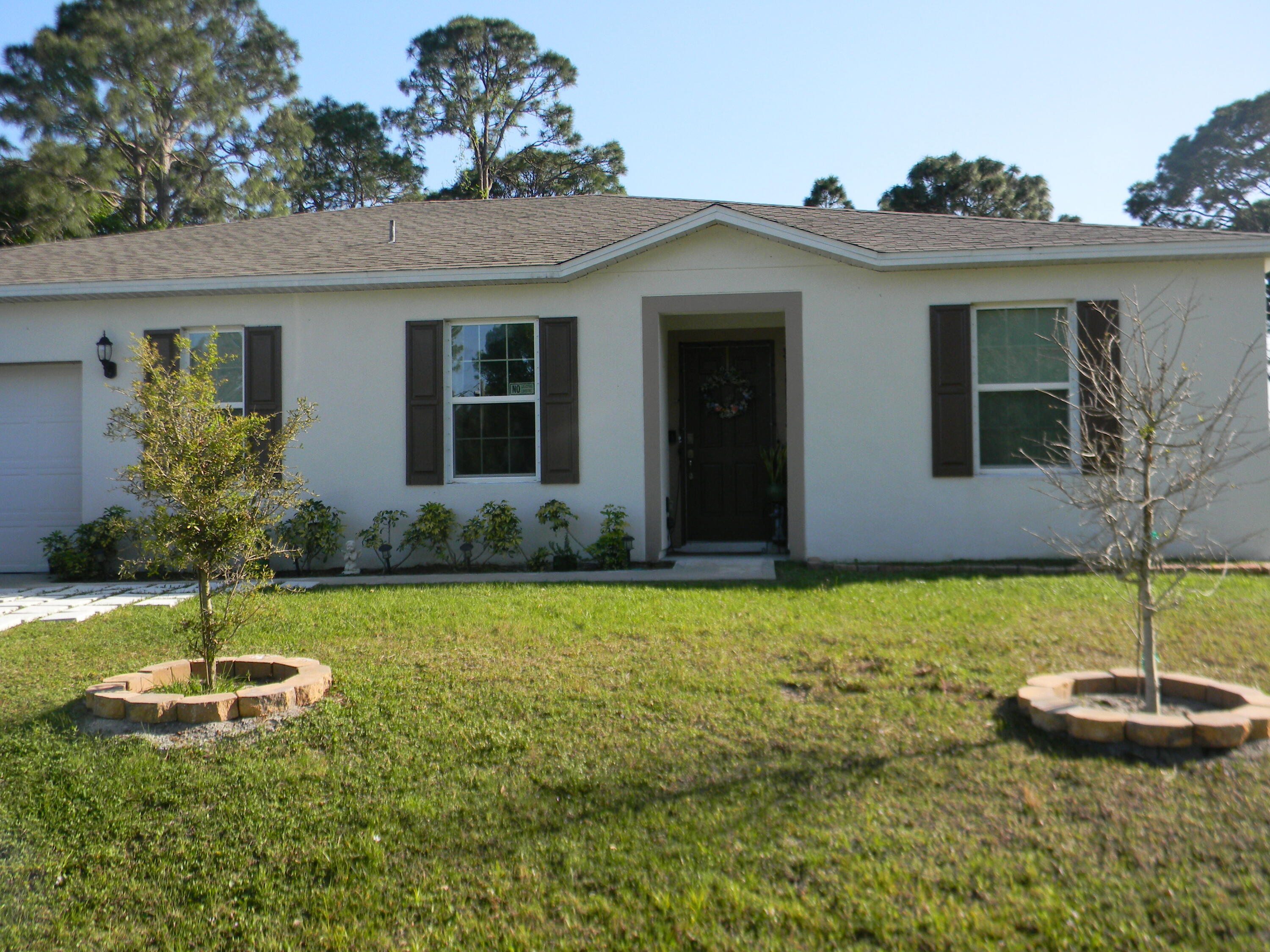 1588 Ranger Road Southeast Palm Bay, FL 32909 - Photo 2 of 52 a front view of a house with a yard