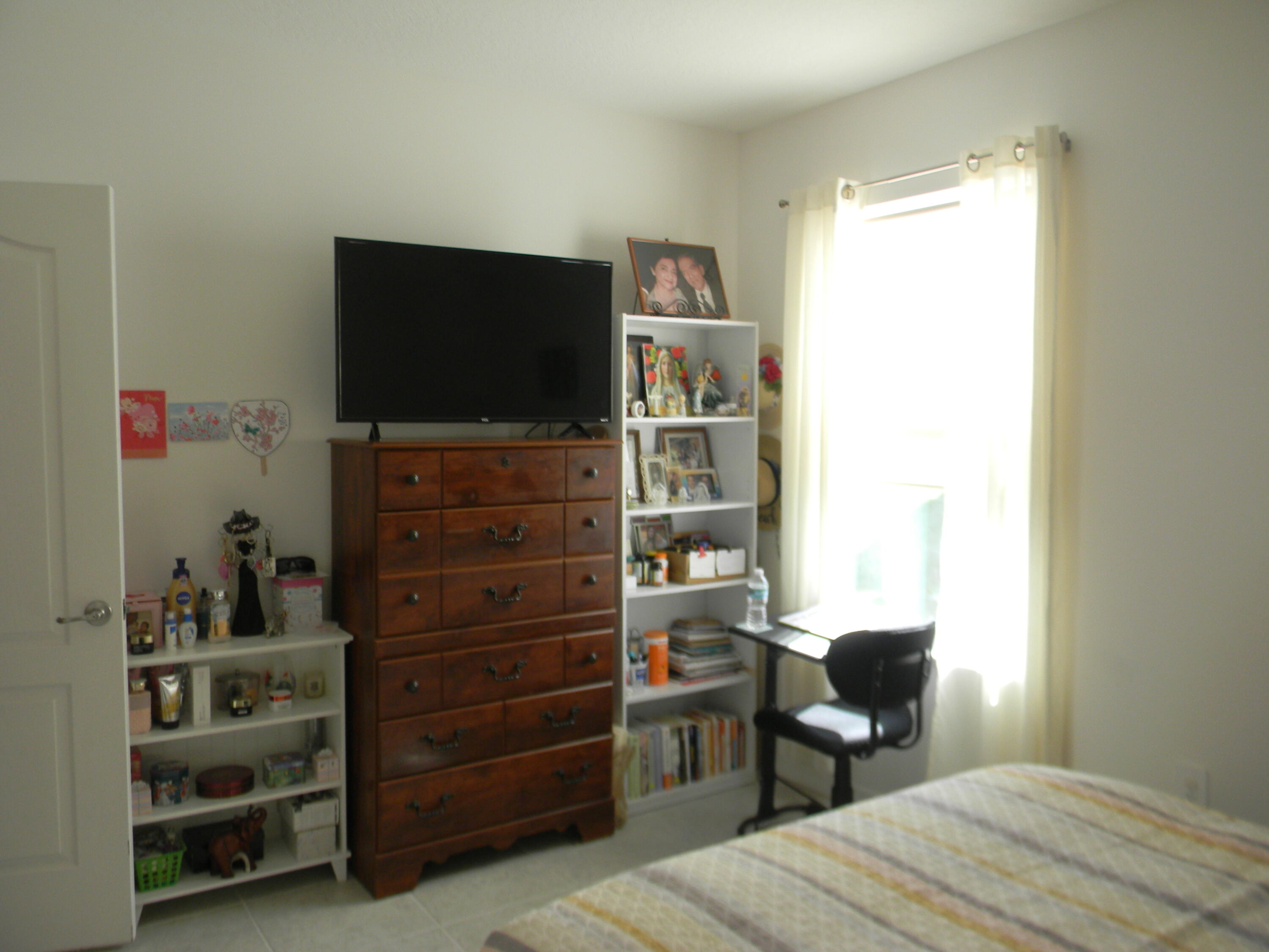 1588 Ranger Road Southeast Palm Bay, FL 32909 - Photo 21 of 52 a room that has a bed and a television in it