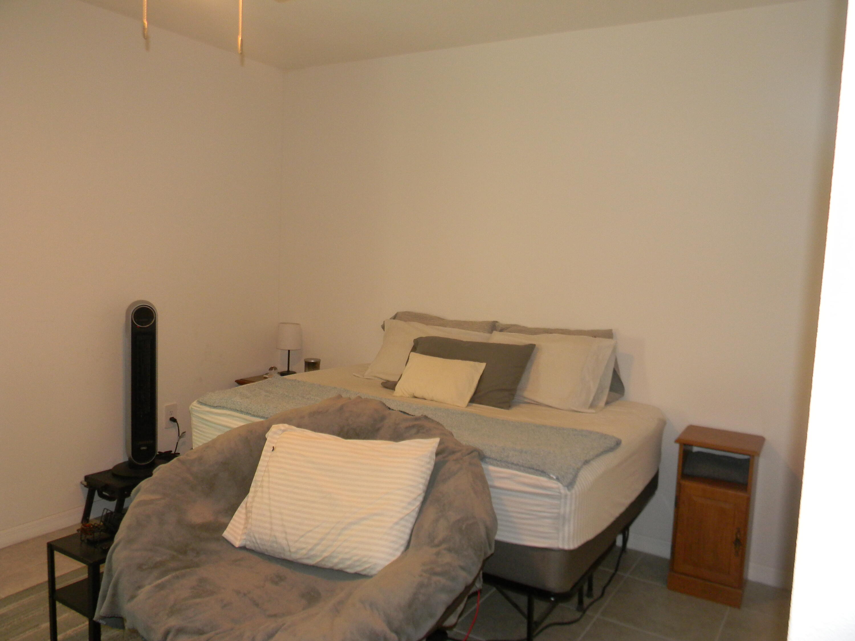 1588 Ranger Road Southeast Palm Bay, FL 32909 - Photo 25 of 52 a bed sitting in a bedroom next to a window