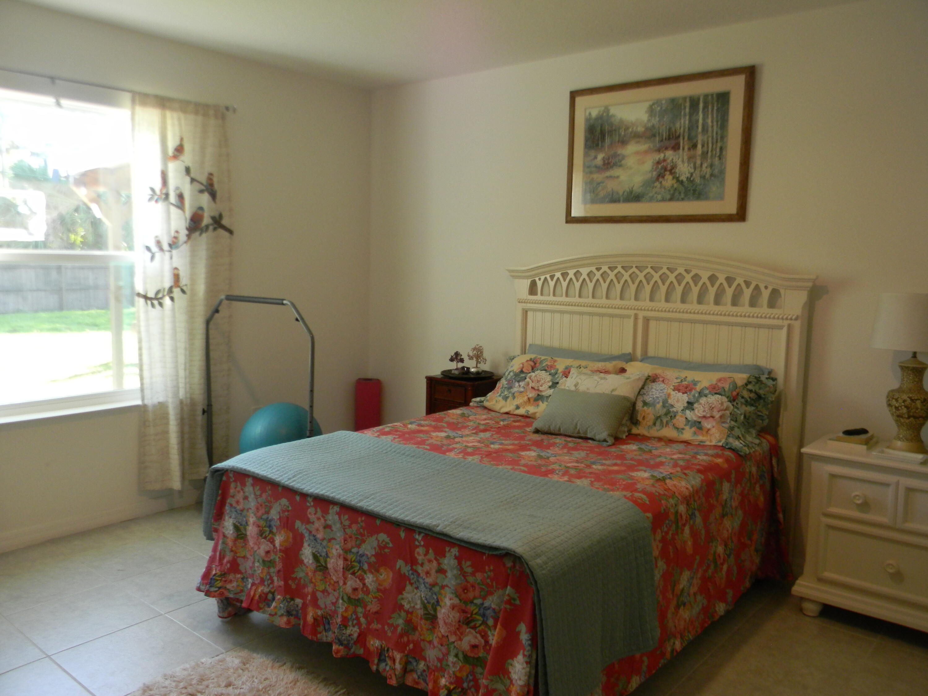 1588 Ranger Road Southeast Palm Bay, FL 32909 - Photo 29 of 52 a bedroom with a bed and a painting on the wall