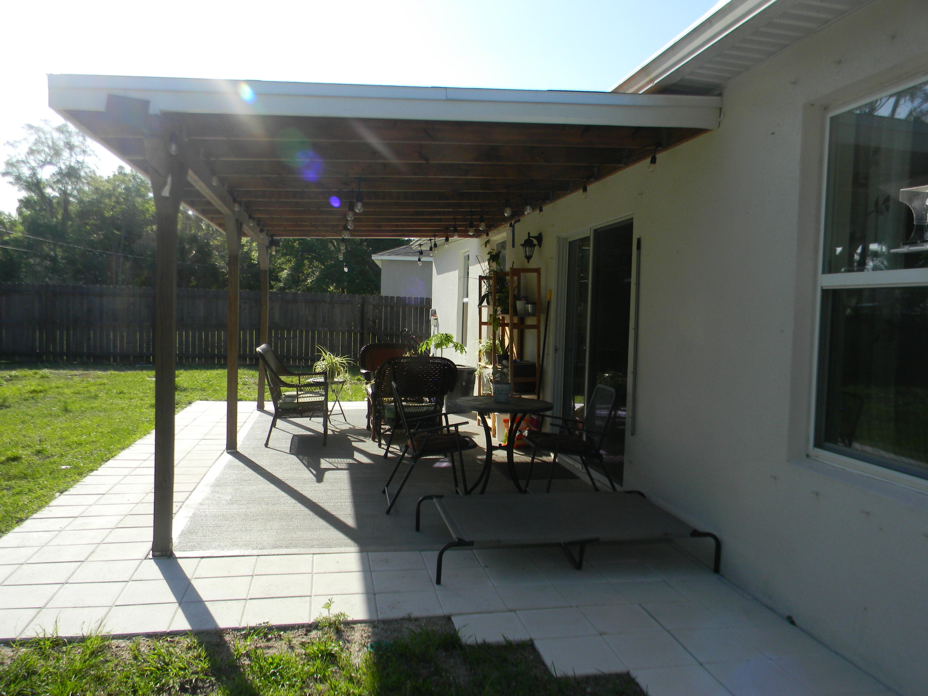 1588 Ranger Road Southeast Palm Bay, FL 32909 - Photo 37 of 52 a living room with patio furniture and a garden