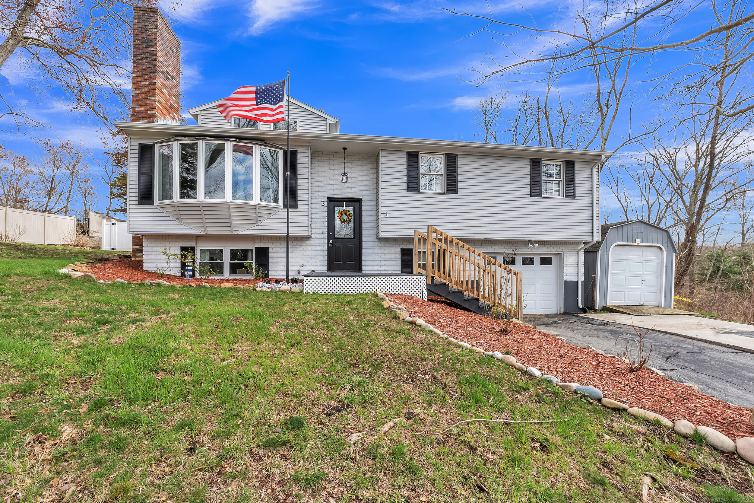 a view of a house with a big yard and large tree