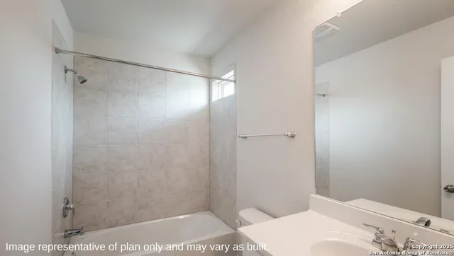 a bathroom with a bathtub and shower