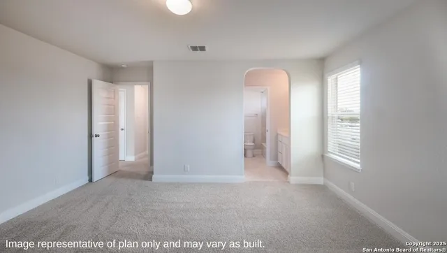 a view of an empty room and a window