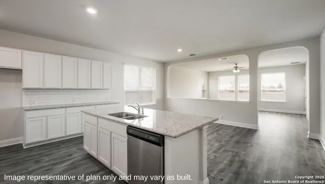 a kitchen with white cabinets and white appliances