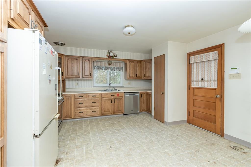 115 Acadia Lane Apollo, PA 15613 - Photo 10 of 20 a kitchen with cabinets wooden floor and stainless steel appliances