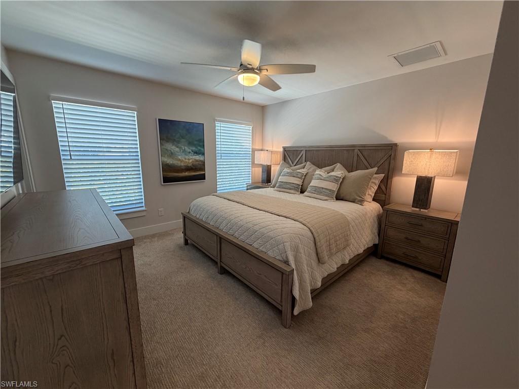 1727 Danford Street Naples, FL 34112 - Photo 13 of 15 a bedroom with a bed lamps and window