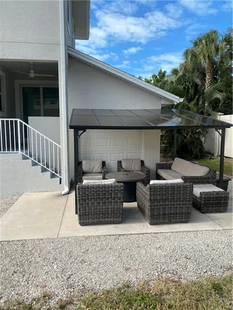 a backyard of a house with sofas