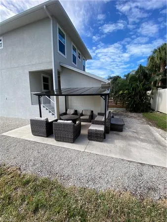 a view of a patio with table and chairs