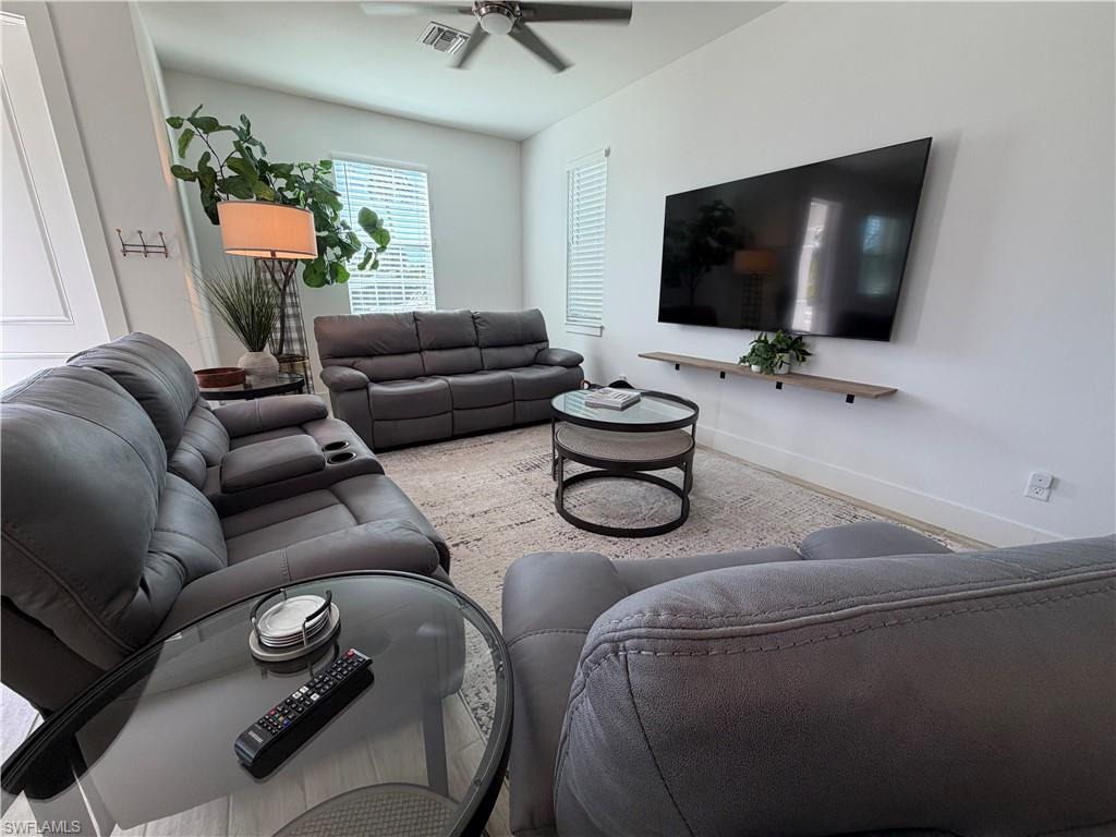 1727 Danford Street Naples, FL 34112 - Photo 5 of 15 a living room with furniture and a flat screen tv