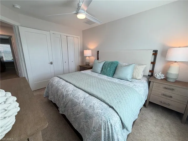 a bedroom with a bed and a lamp