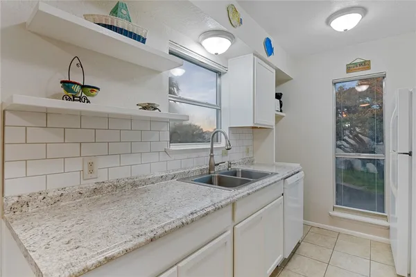 a kitchen with a sink and a refrigerator