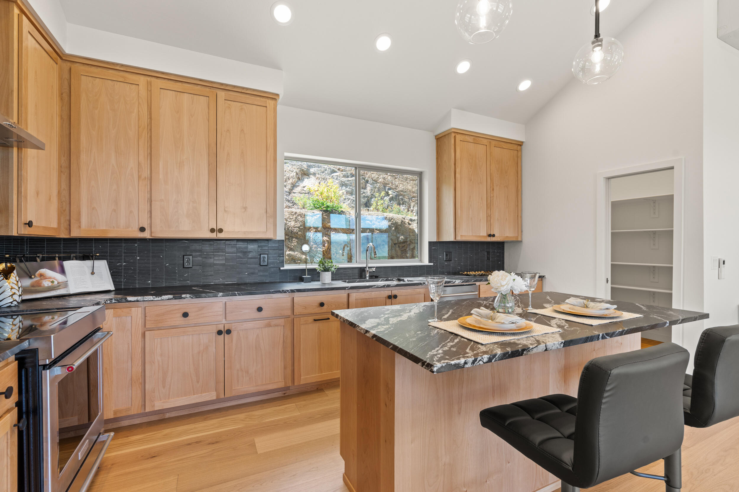 3060 Ashland Mine Road Talent, OR 97540 - Photo 12 of 43 a kitchen with a table chairs stove and cabinets