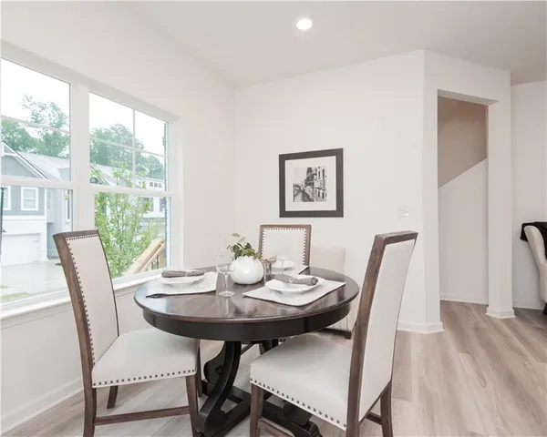 a view of a dining room with furniture window and wooden floor