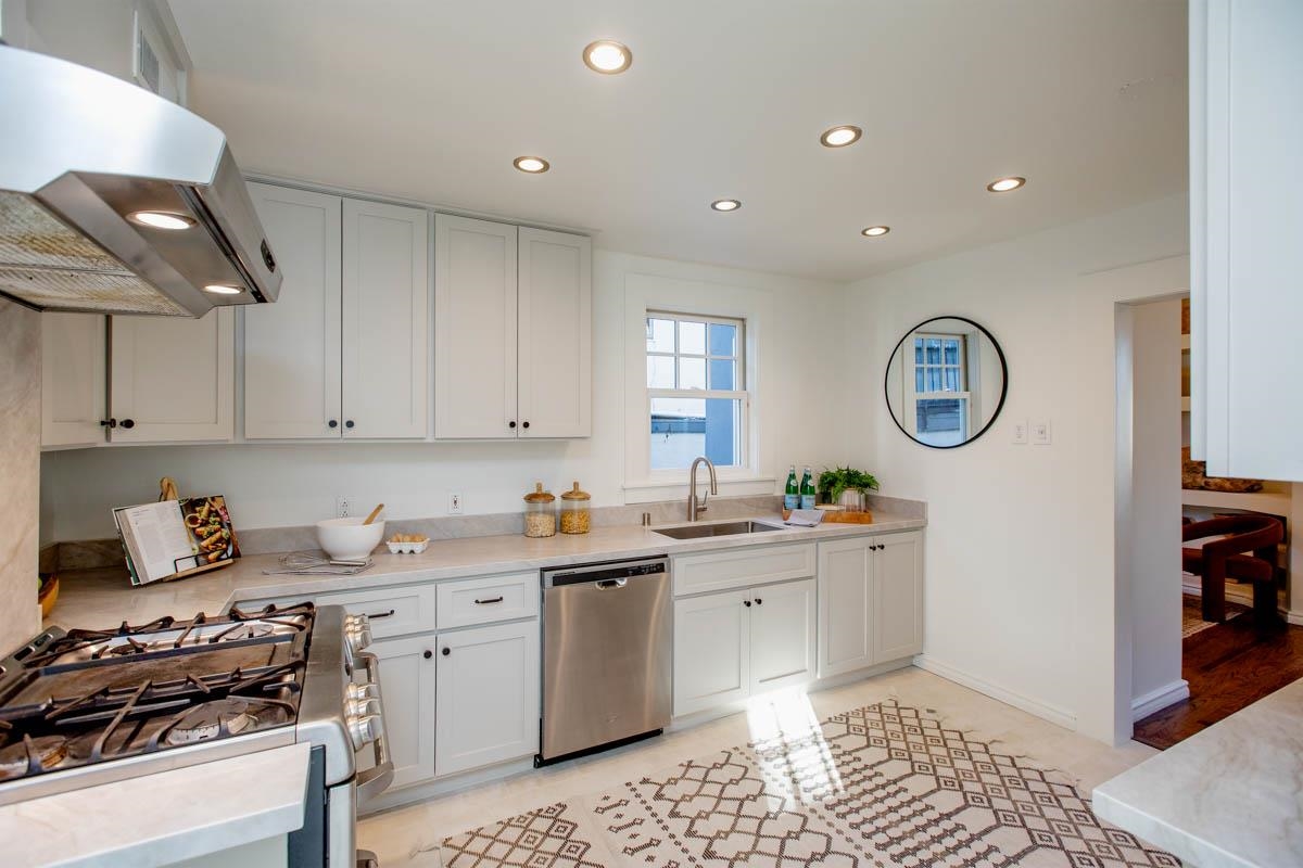 1427 Bay Street Alameda, CA 94501 - Photo 12 of 60 a kitchen with a sink a stove cabinets and wooden floor