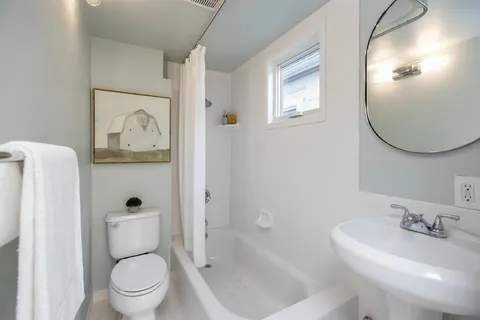 a en suite bathroom with a double vanity sink and a mirror
