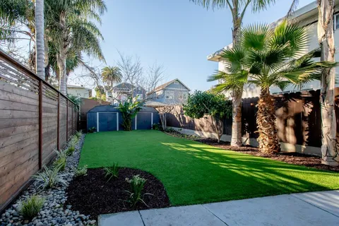 a spacious bedroom with a bed a couch and dresser