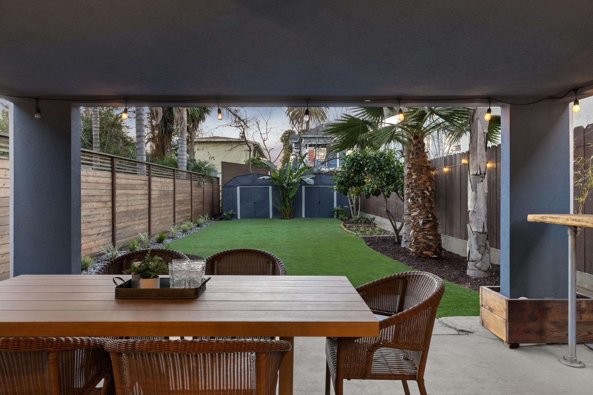 1427 Bay Street Alameda, CA 94501 - Photo 58 of 60 a view of a patio with table and chairs a barbeque with wooden fence