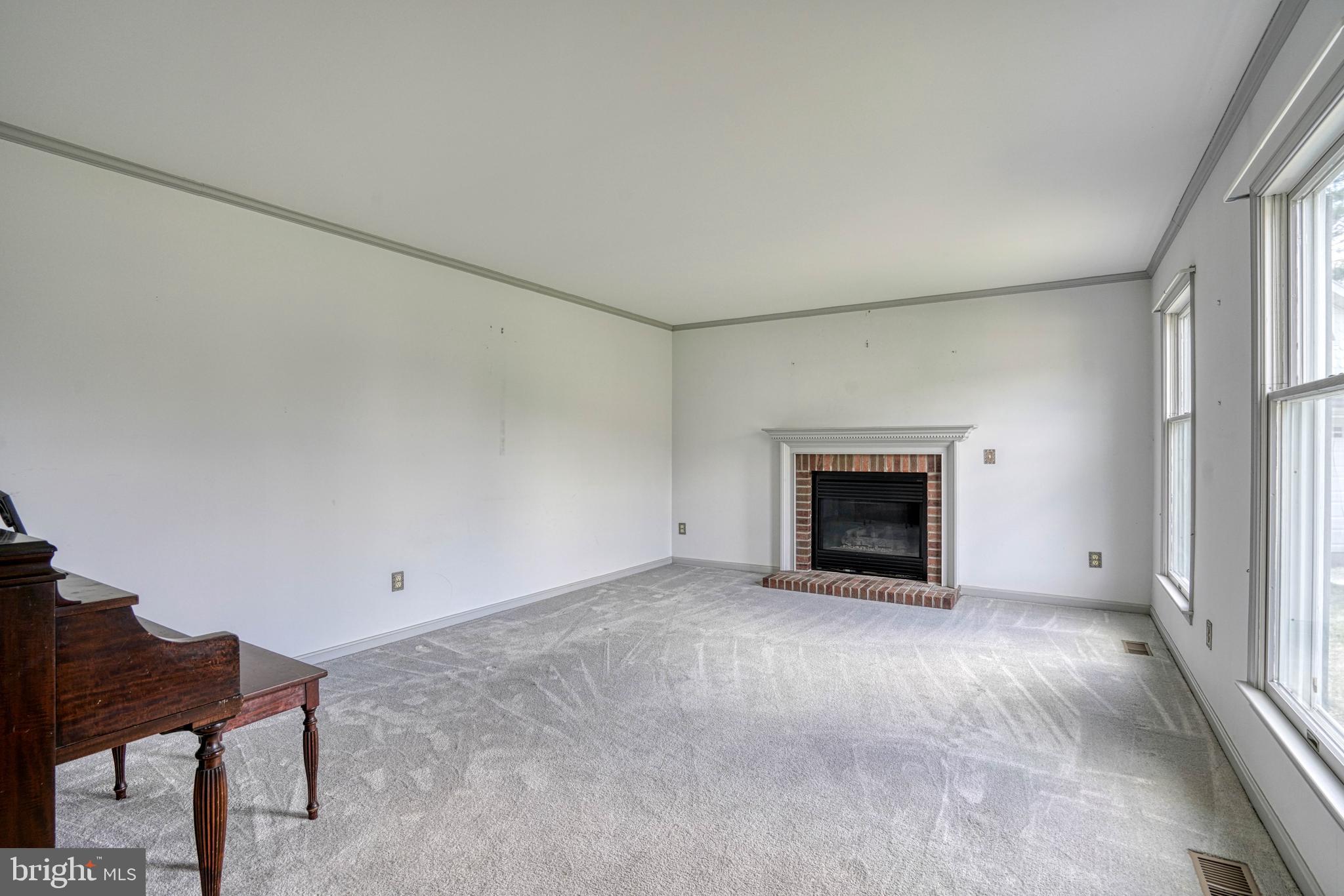200 Spring Drive Easton, MD 21601 - Photo 12 of 54 a view of an empty room with a fireplace and a window