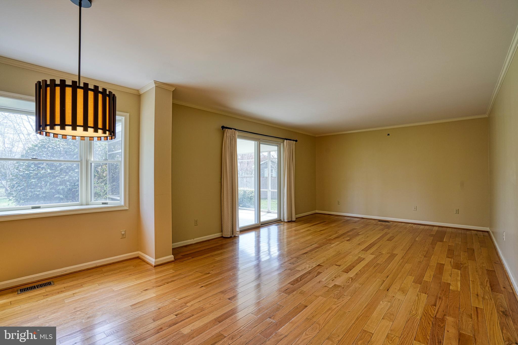 200 Spring Drive Easton, MD 21601 - Photo 17 of 54 a view of an empty room with wooden floor and a window