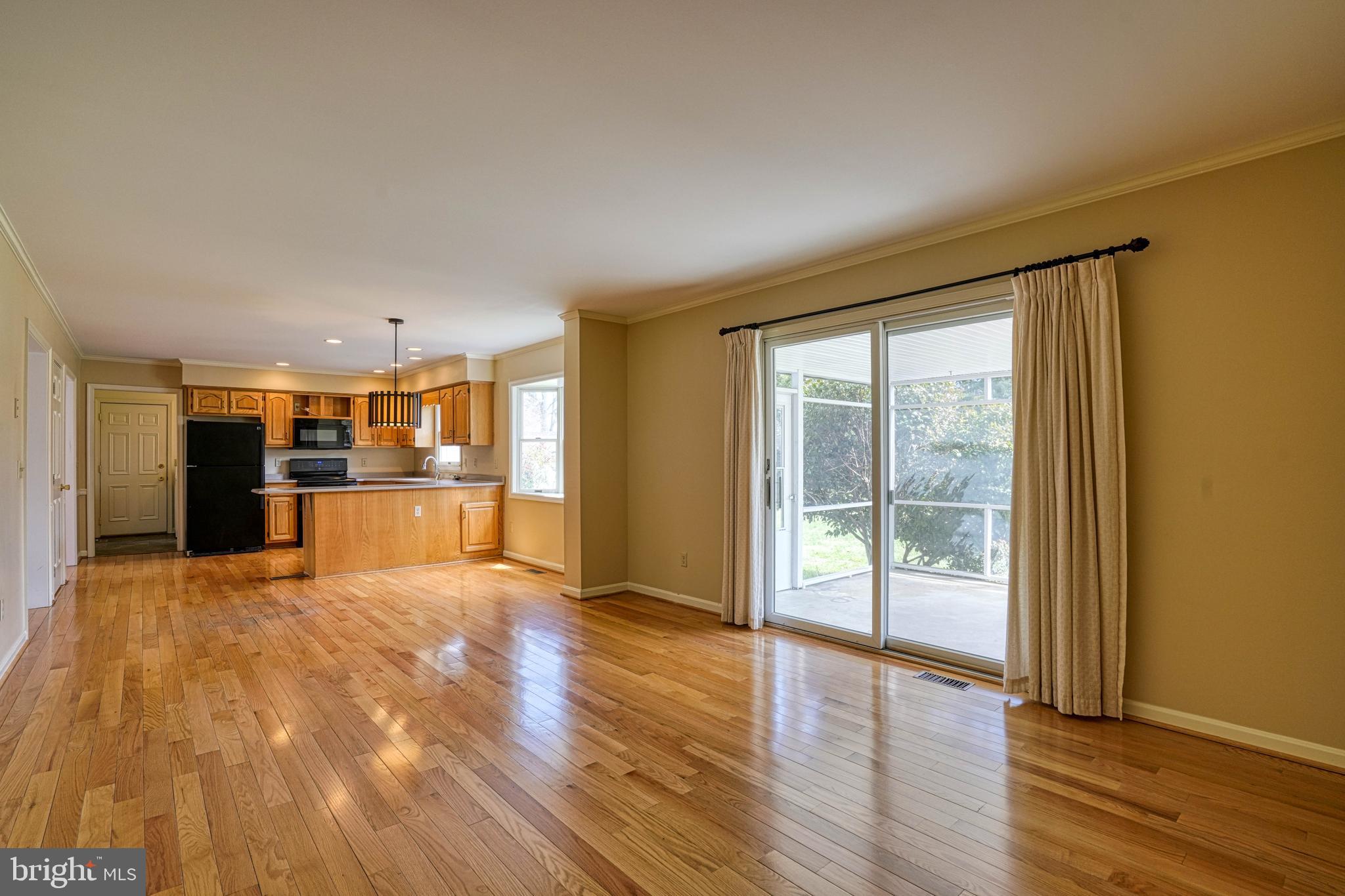 200 Spring Drive Easton, MD 21601 - Photo 18 of 54 a view of empty room with wooden floor and floor to ceiling window