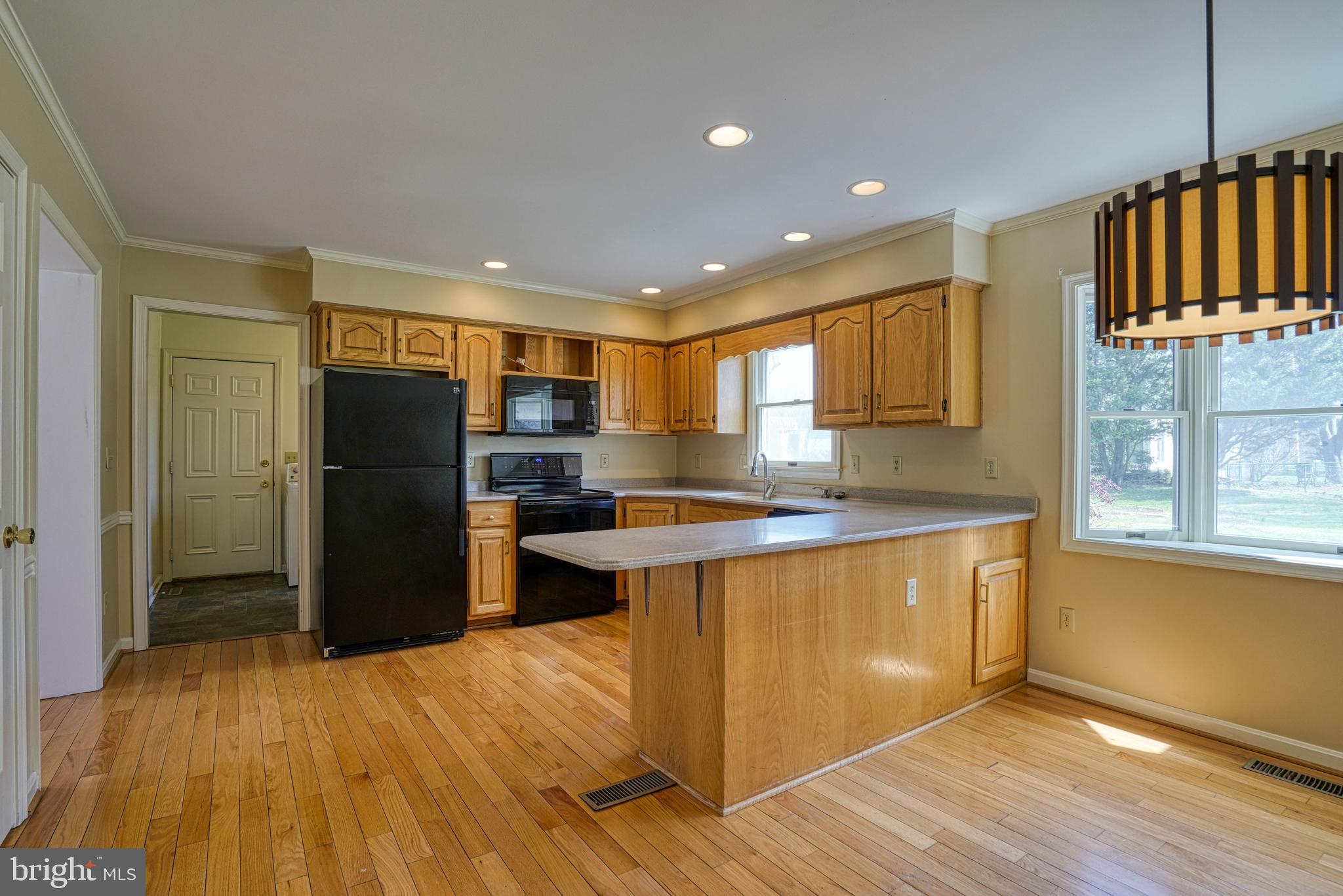 200 Spring Drive Easton, MD 21601 - Photo 21 of 54 a kitchen with stainless steel appliances granite countertop a refrigerator a sink a stove a microwave and island