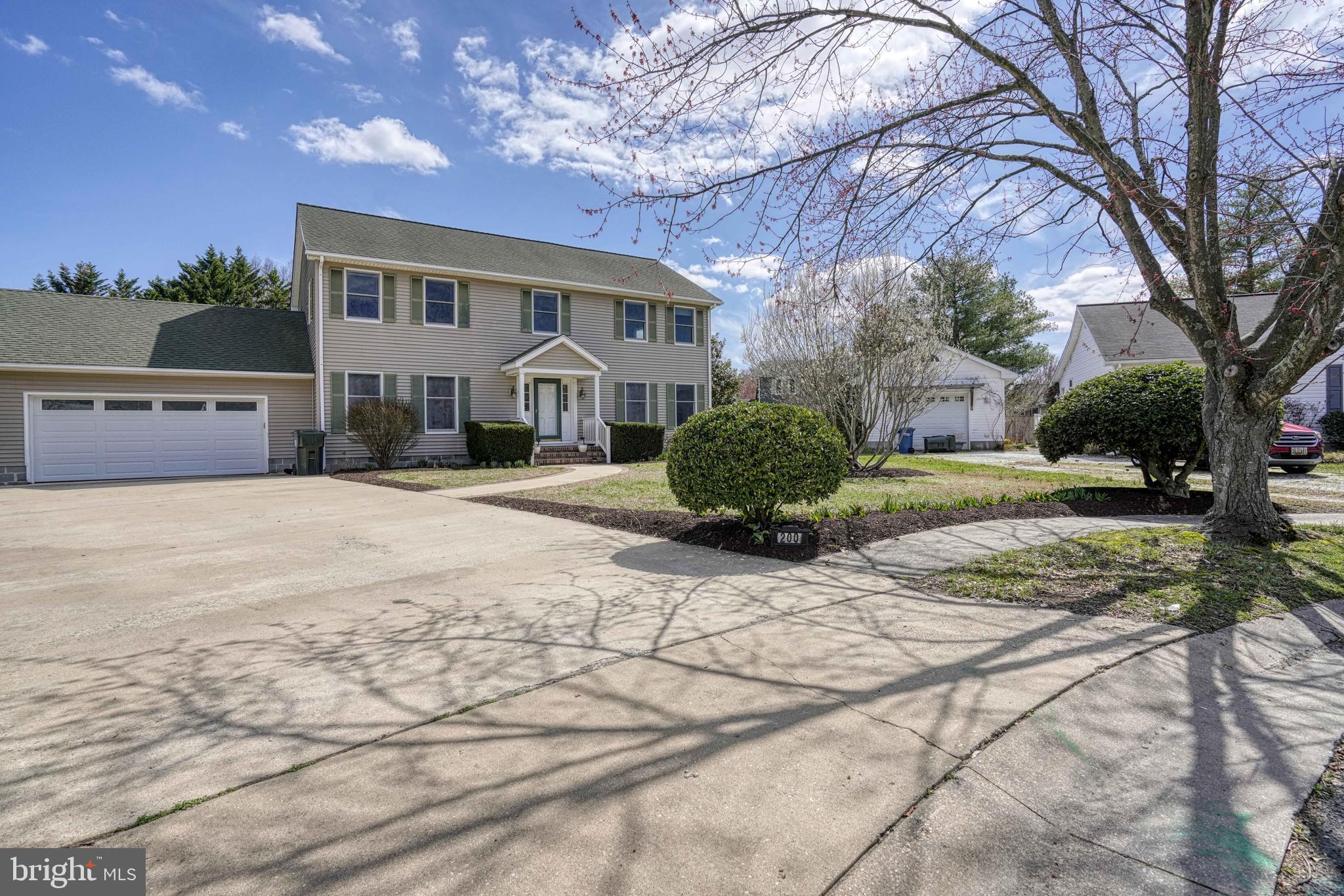 200 Spring Drive Easton, MD 21601 - Photo 3 of 54 a front view of a house with a yard and trees