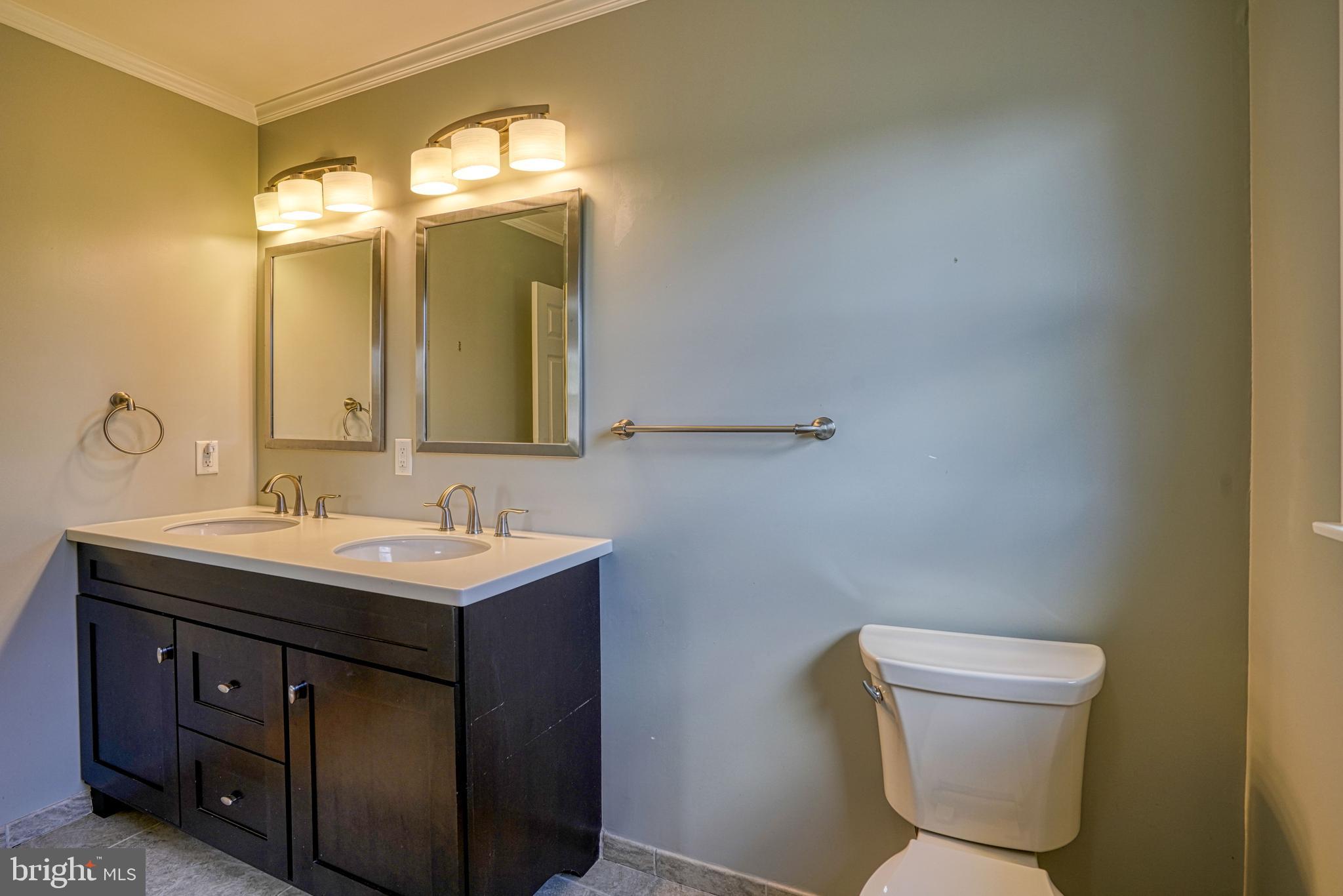 200 Spring Drive Easton, MD 21601 - Photo 34 of 54 a bathroom with a toilet sink and mirror
