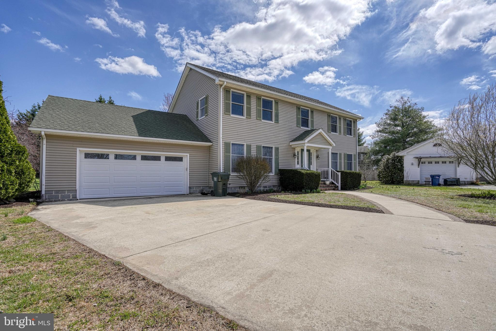 200 Spring Drive Easton, MD 21601 - Photo 4 of 54 a front view of a house with a yard and garage
