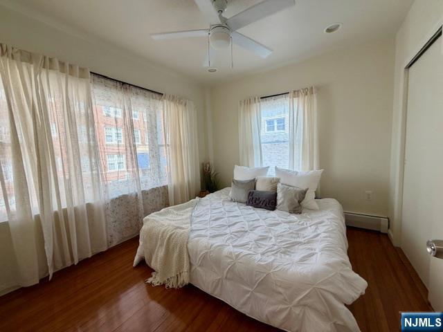 10 Fairview Place Bloomfield, NJ 07003 - Photo 11 of 20 a bedroom with a large bed and wooden floor