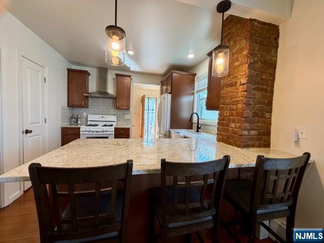 10 Fairview Place Bloomfield, NJ 07003 - Photo 6 of 20 a dining room with stainless steel appliances kitchen island a table chairs and a refrigerator