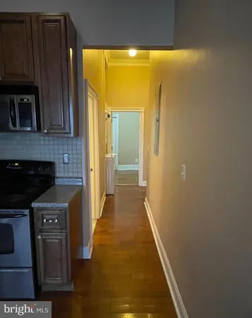 a kitchen with stainless steel appliances wooden cabinets and a stove top oven