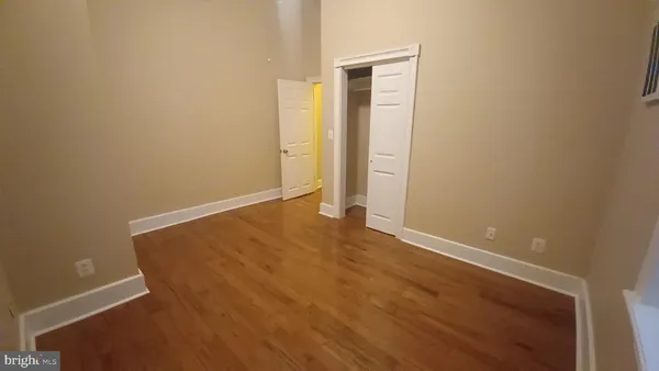 a bedroom with a bed and a lamp