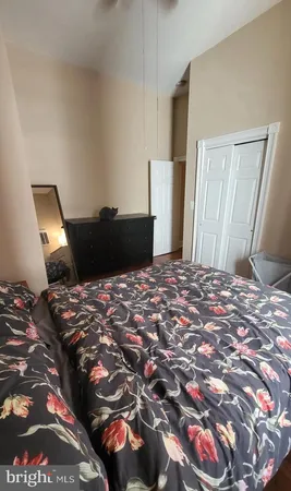 a view of a room with wooden floor and a window