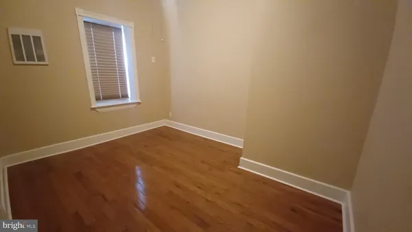 a bedroom with a bed next to a window