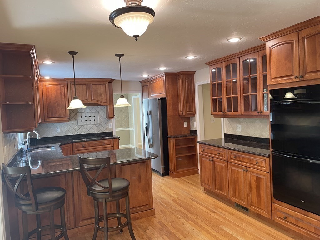 25 Upson Road Wellesley, MA 02482 - Photo 7 of 32 a kitchen with stainless steel appliances granite countertop a refrigerator and a stove top oven