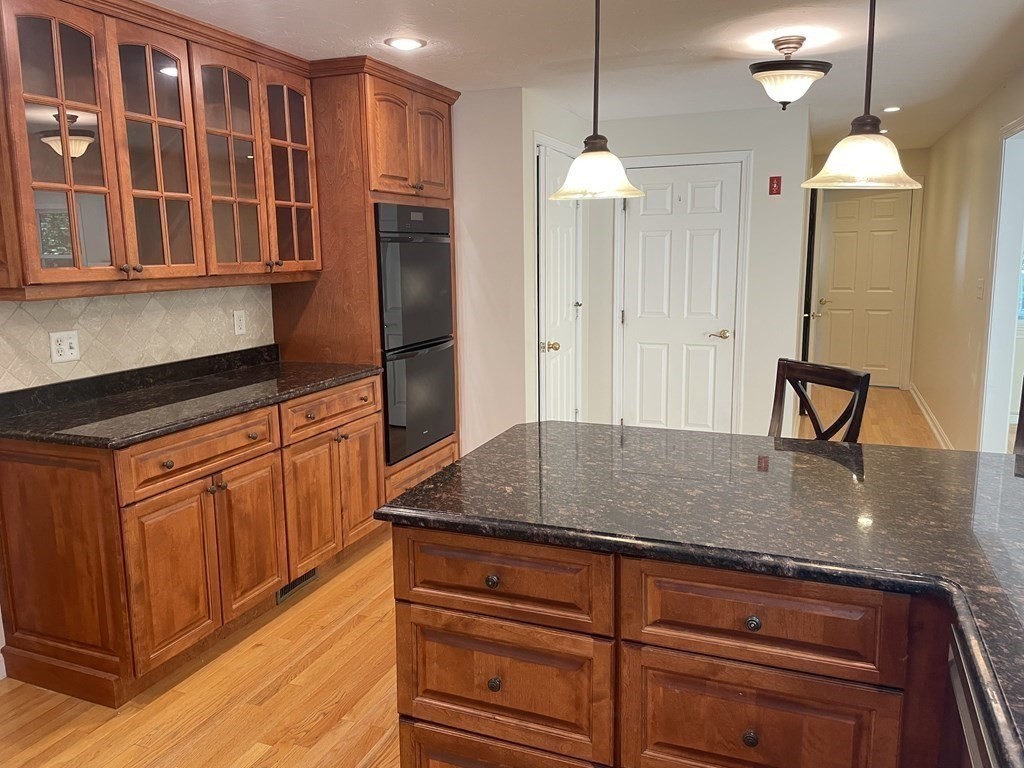 25 Upson Road Wellesley, MA 02482 - Photo 8 of 32 a kitchen with stainless steel appliances granite countertop a sink and a refrigerator