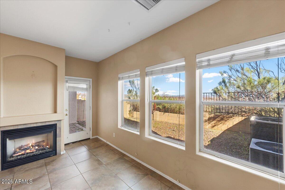 813 Alfonse Road Clarkdale, AZ 86324 - Photo 3 of 41 a view of an empty room with a fireplace and a window