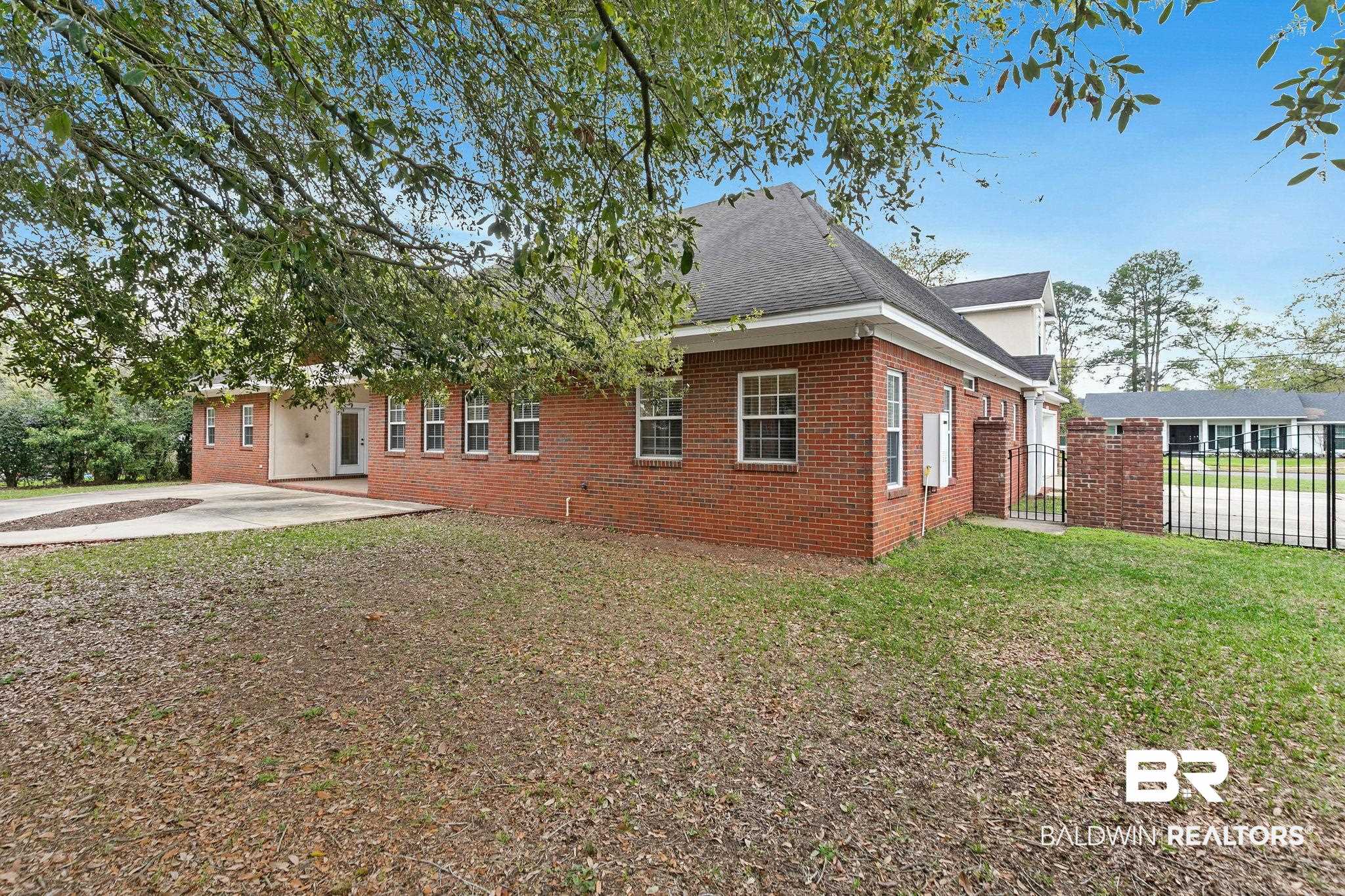 3668 Claridge Road North Mobile, AL 36608 - Photo 92 of 100 View of front of property with brick siding, roof with shingles, a patio, and a gate